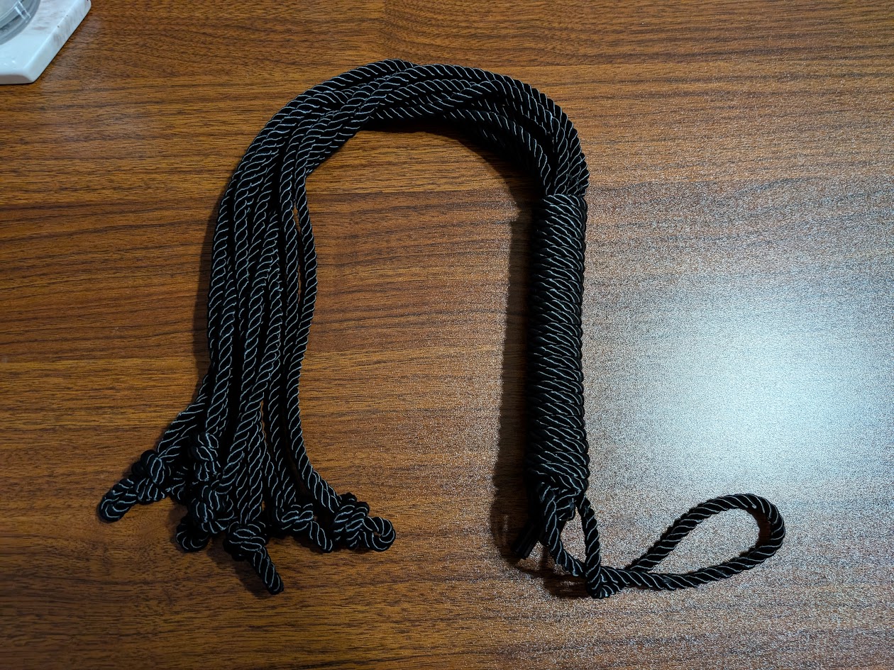 a flogger made from black rope
